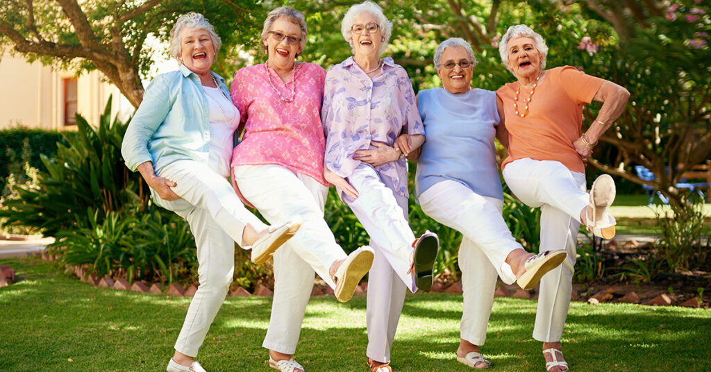 Senior women laughing doing the can can dance